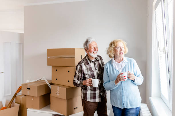 istock Senior Couple at Moving Day Looking Through the Window 1159164186