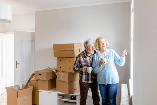 istock Senior Couple at Moving Day Looking Through the Window 1159164222