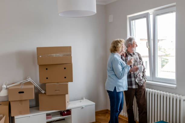 istock Senior Couple at Moving Day Looking Through the Window 1159164223