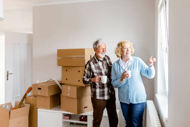 istock Senior Couple at Moving Day Looking Through the Window 1159164225