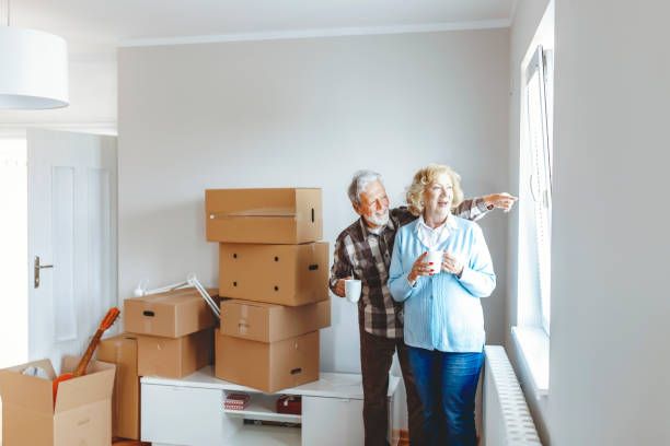istock Senior Couple at Moving Day Looking Through the Window 1159164228