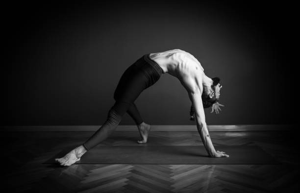 istock Man doing Wild Thing pose (Camatkarasana ) in yoga 1159165405