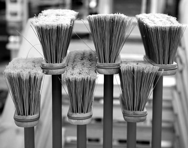 Upside-down brooms in black and white