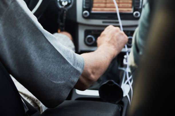 homme changeant l'engrenage manuel tout en conduisant une voiture sur la rue - car driving men reversing photos et images de collection