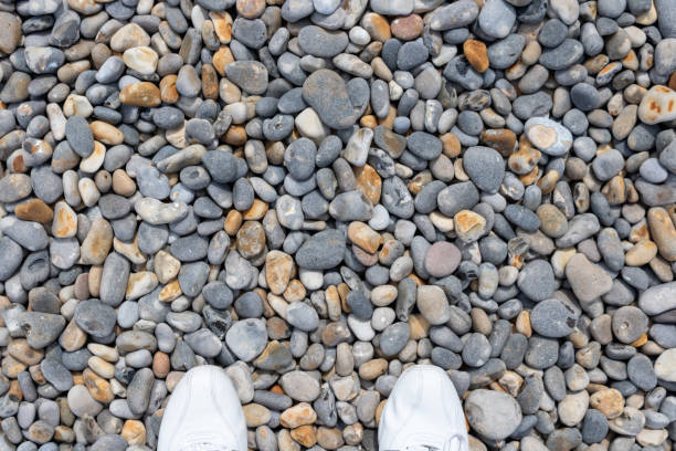 istock White shoes on a pebbled stone 1159168684