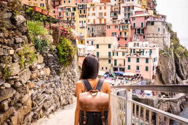 Female tourist visiting Riomaggiore. Beautiful town in Cinque Terre coast