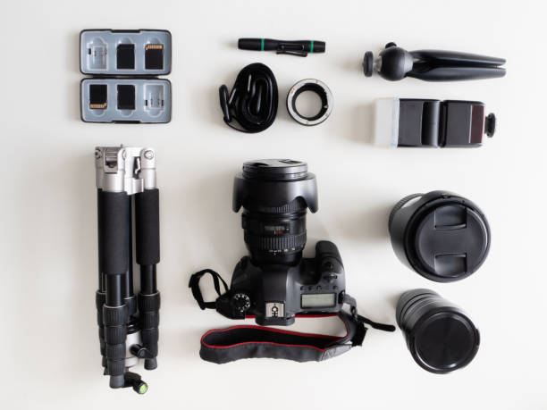 istock top view of work space photographer with digital camera, flash, cleaning kit, memory card, tripod and camera accessory on white table background 1159170844