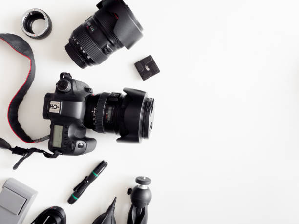 istock top view of work space photographer with digital camera, flash, cleaning kit, memory card, tripod and camera accessory on white table background 1159170852