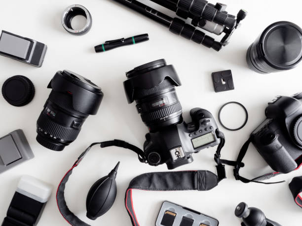 istock top view of work space photographer with digital camera, flash, cleaning kit, memory card, tripod and camera accessory on white table background 1159170853