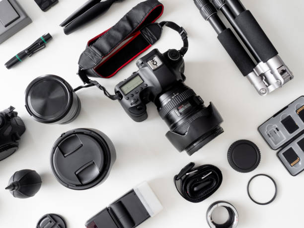 istock top view of work space photographer with digital camera, flash, cleaning kit, memory card, tripod and camera accessory on white table background 1159170859