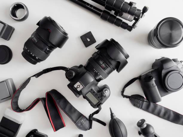 istock top view of work space photographer with digital camera, flash, cleaning kit, memory card, tripod and camera accessory on white table background 1159170860