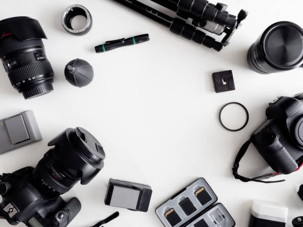 istock top view of work space photographer with digital camera, flash, cleaning kit, memory card, tripod and camera accessory on white table background 1159170897