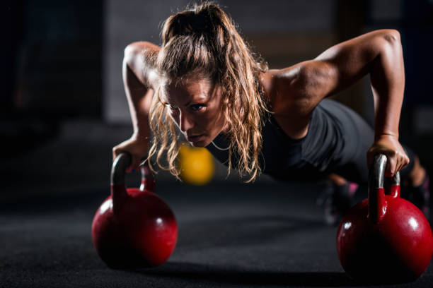 istock Woman athlete exercising with kettlebell 1159171750