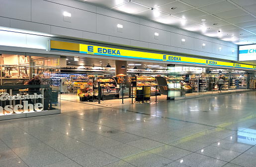 Germany - 14 June 2018: front side with sign of Edeka shop supermarket inside airport, Munich Germany