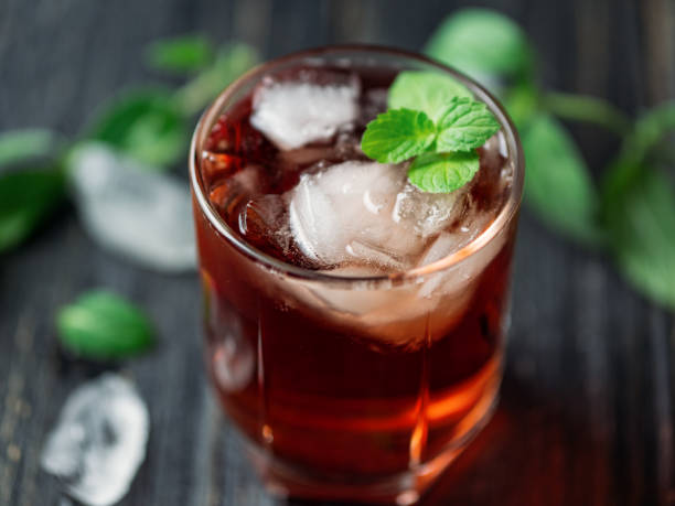 istock Red cocktail with mint in a glass on a dark wooden table 1159172006