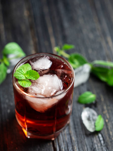 istock Red cocktail with mint in a glass on a dark wooden table 1159172014