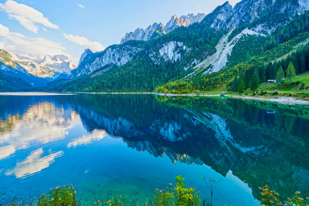 istock Beautiful Gosausee lake landscape with Dachstein mountains, forest, clouds and reflections in the water in Austrian Alps. Salzkammergut region. 1159172931