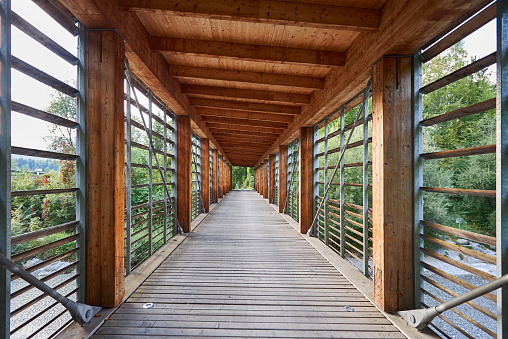 Wooden bridge over river in Austria, Salzburg region.