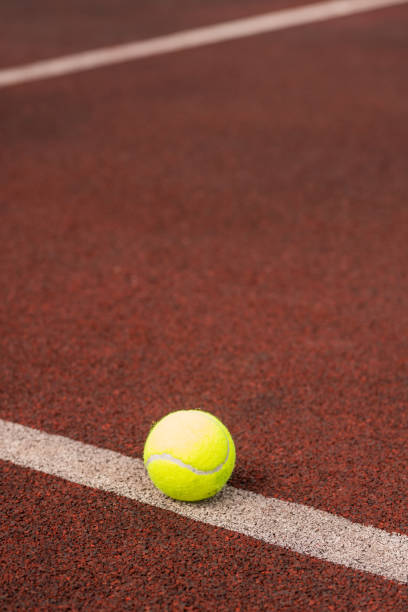 istock Single yellow ball for playing tennis on white line 1159175679