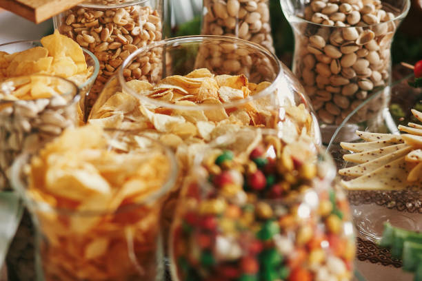 istock Delicious beer appetizers table at wedding reception. Chips, salty nuts, pistachio, cheese snacks on table at wedding or christmas feast. Luxury catering concept. Beer bar 1159176589