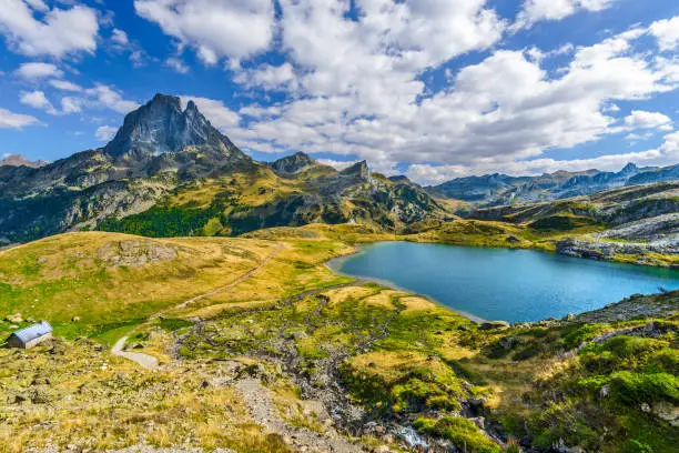 Photo of View at Midi Ossau mountain peak and Lake Roumassot, in Ayous-Bious valley in French Atlantic Pyrenees, as seen in October. Aquitaine, France.