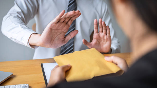istock Anti bribery and corruption concept, Business man refusing and don't receive money banknote in envelope offer from business people to accept agreement contract of investment deal 1159177272