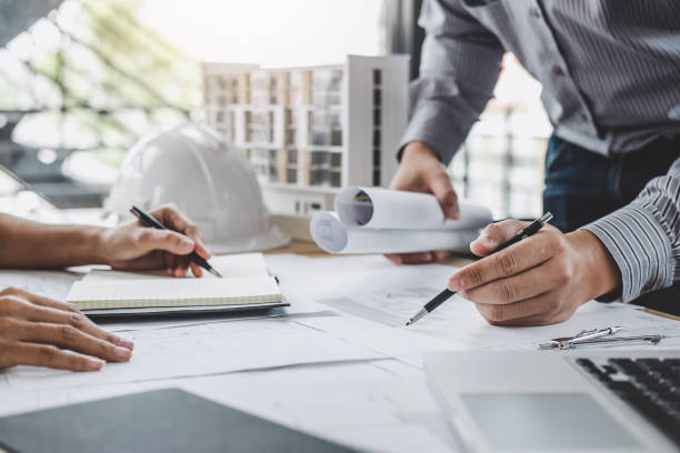 istock Architecture Engineer Teamwork Meeting, Drawing and working for architectural project and engineering tools on workplace, concept of worksite on technical drawing structure and construction 1159177903