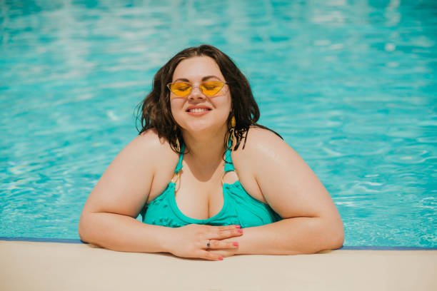 istock Curvy woman resting by the pool. 1159178234