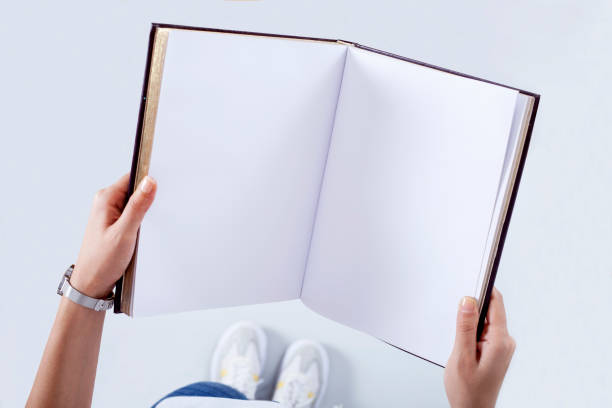 istock Person holding white empty paper 1159178250