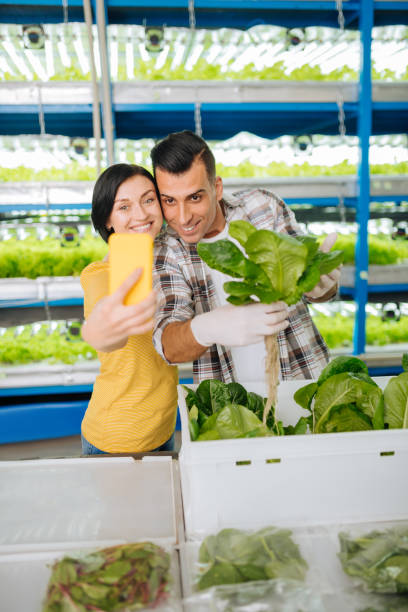 istock Wife and husband making selfie while standing in greenhouse 1159179142