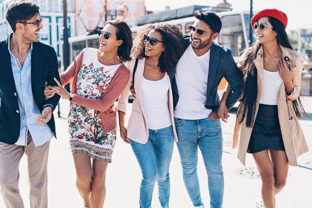 istock Group of friends walking outdoors on a sunny day 1159179642