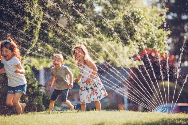 Kids playing with sprinkler