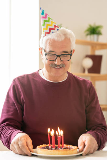 istock Happy senior man making birthday wish 1159183849