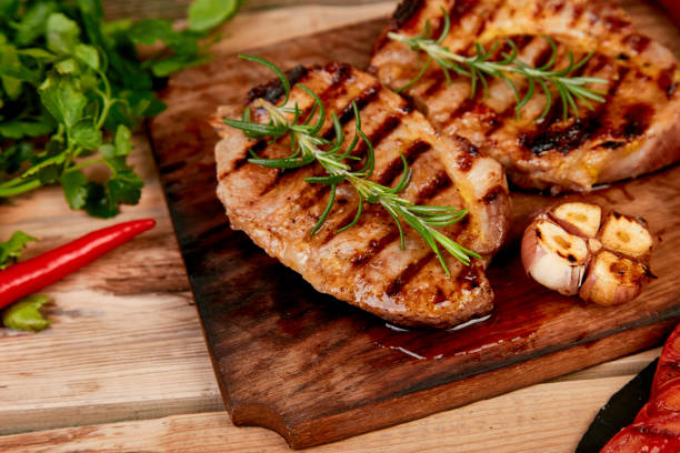 istock Steak pork grill on wooden cutting board 1159187478