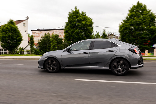 Zagreb, Croatia - May 12, 2019: New Honda Civic in grey colour in motion on the streets of Zagreb. Front view of the car.