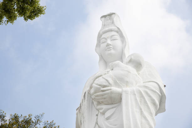 the statue of giant Guanyin or Kannon goddess of mercy carrying children at Daihonzan Naritasan Kurume Temple. stock photo