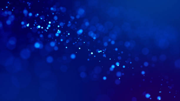 istock glow blue particles on blue background are hanging in air for bright festive presentation with depth of field and light bokeh effects. Version 18 1159187906