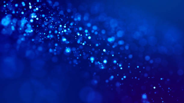 istock glow blue particles on blue background are hanging in air for bright festive presentation with depth of field and light bokeh effects. Version 19 1159187919