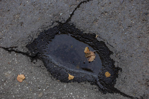istock texture of a small puddle on asphalt 1159188058