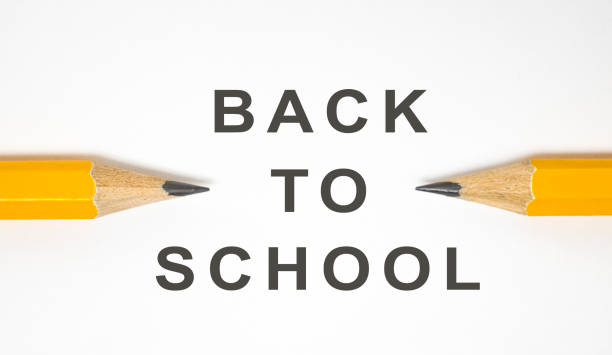 istock Back to school concept. Close-up two yellow pencils on white background with copy space 1159188070