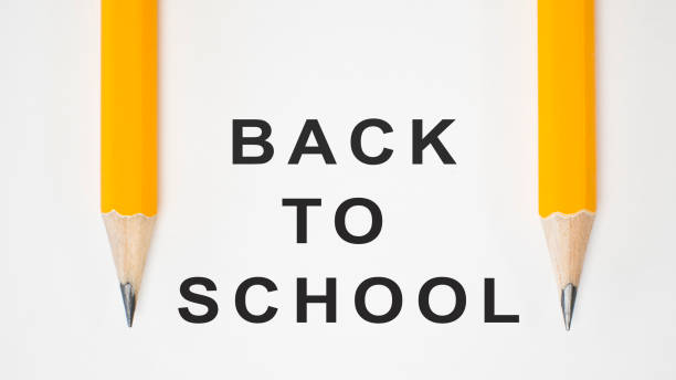 istock Back to school concept. Close-up two yellow pencils on white background with copy space 1159188089