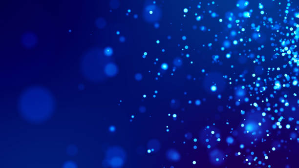 Microcosm. Glow blue particles on blue background are hanging in air for bright festive presentation with depth of field and light bokeh effects. Version 29