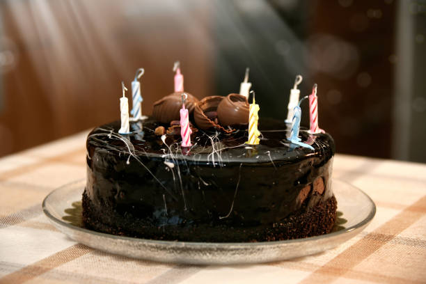 istock close up birthday cake with candles on table 1159191942
