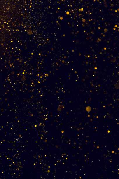 istock Glitter abstract background shiny particles golden dust 1159193649