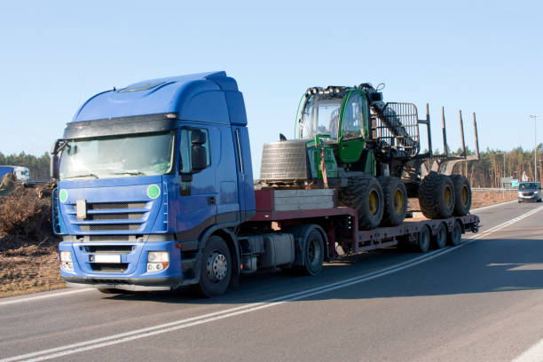 truck carrying tractor