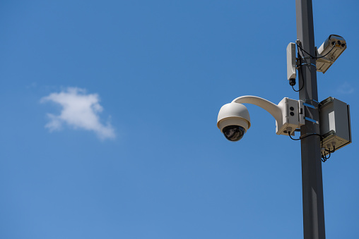CCTV cameras mounted on the pole over sky copy space