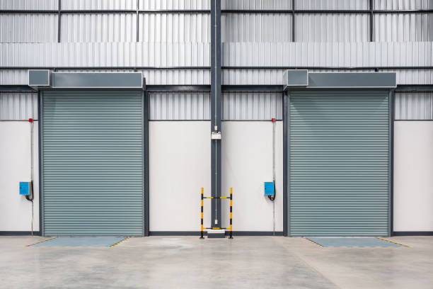 istock Roller shutter door and concrete floor inside factory. Industrial concept 1159196442
