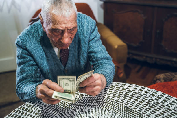 istock Senior man holding savings 1159196560