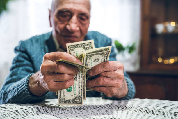 istock Senior man holding savings 1159196609