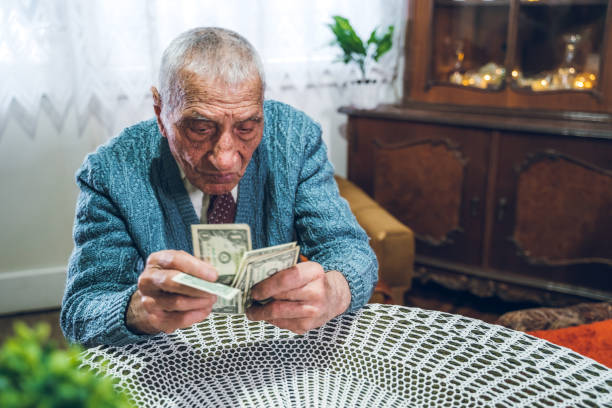 istock Senior man holding savings 1159197230